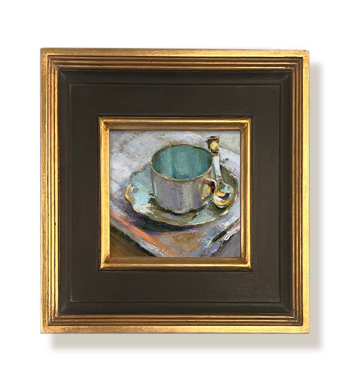 A Favorite gold framed oil painting featuring a mug and saucer. By artist Jennifer Hansen Rolli.