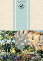 A square art print or decorative panel featuring a painted garden scene with a sunlit stone house and lush foliage, with a beige linen-textured top section and pale blue vertical stripes containing a monogram logo.