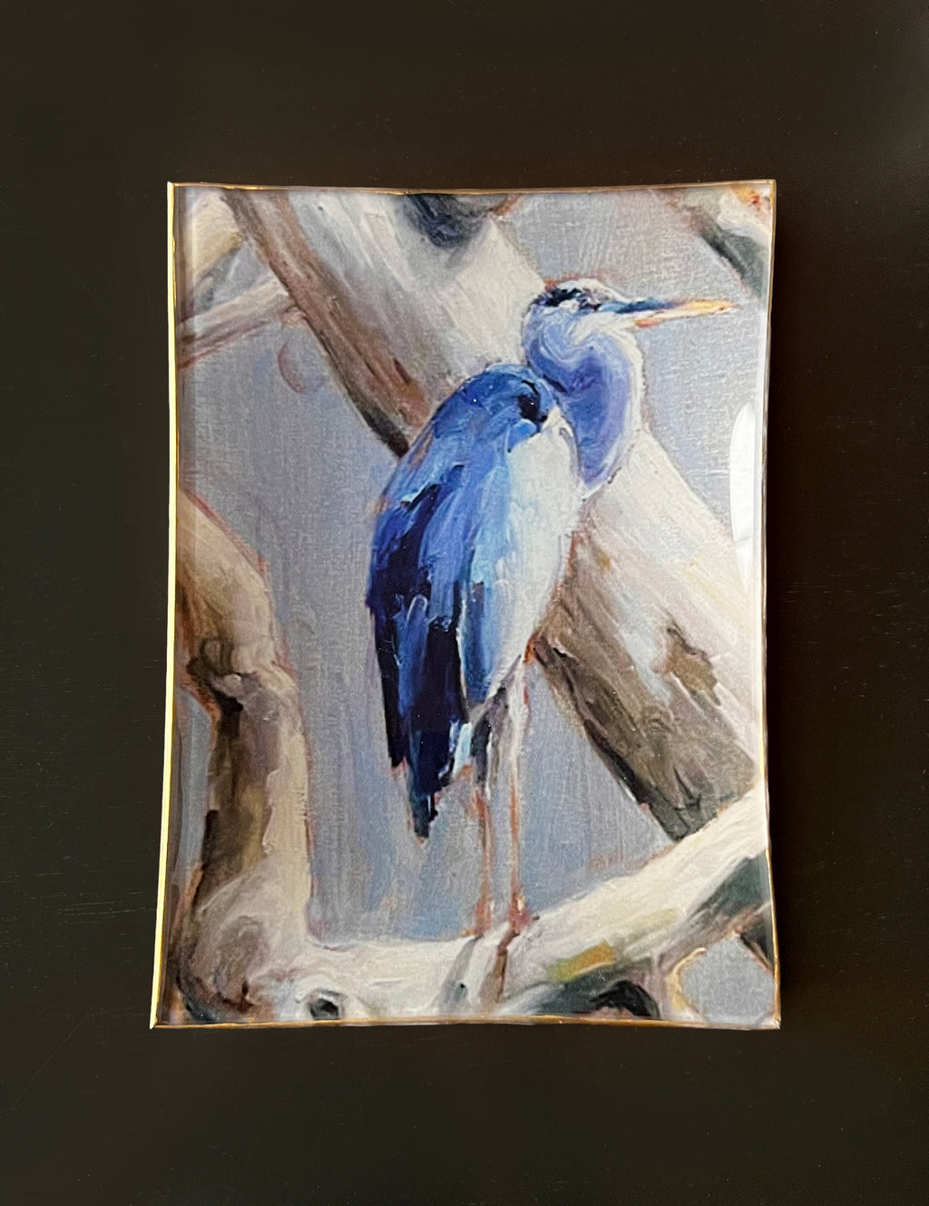 Painting of a blue heron on a branch with a dark background