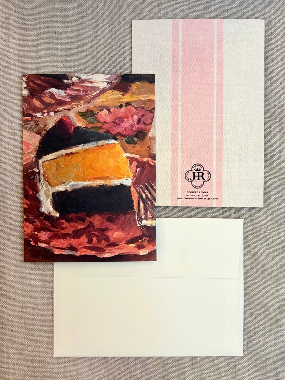 A stationery set laid flat on a textured neutral background, featuring a rectangular card with an abstract food painting, a white envelope, and a white card with pink vertical stripes and a small circular logo.