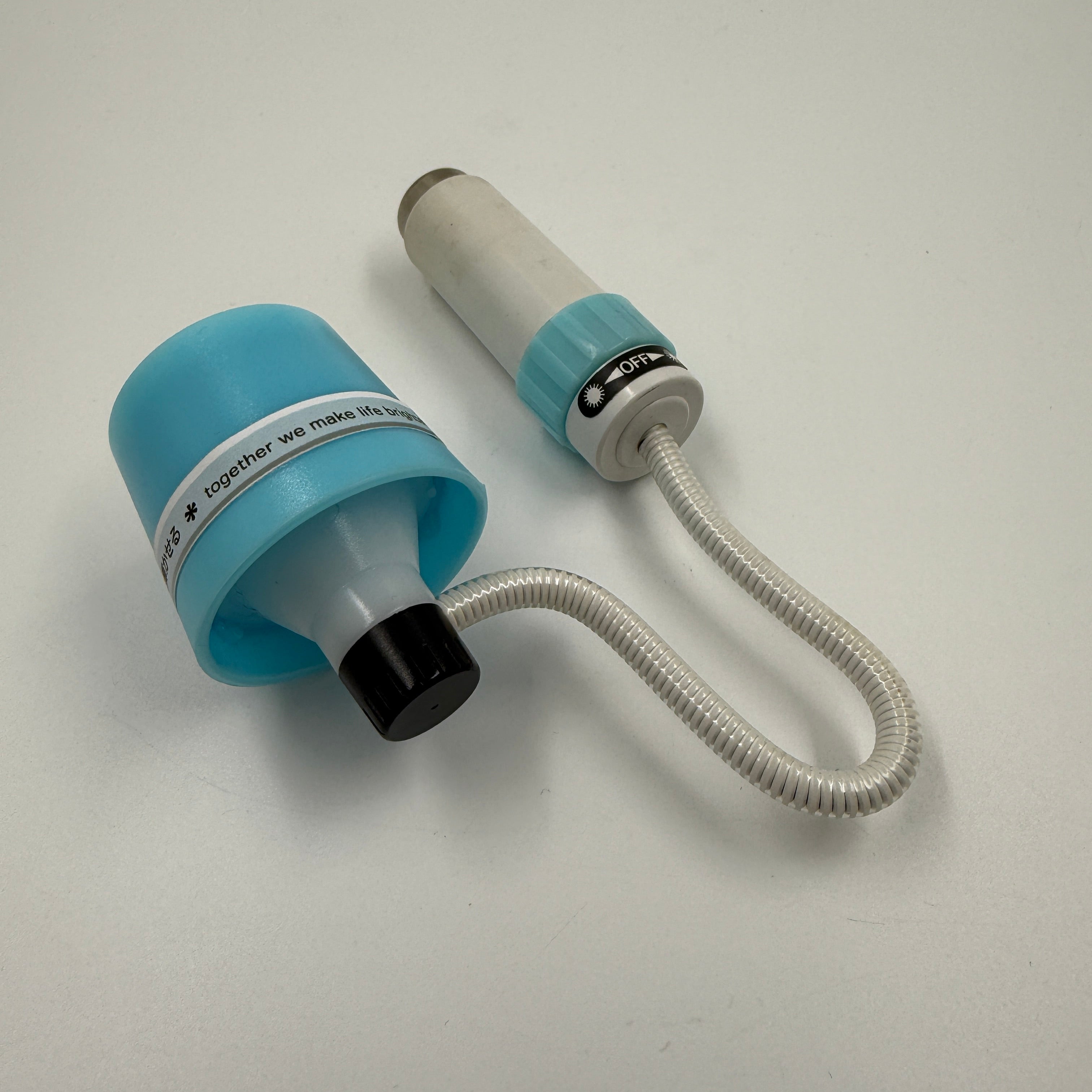 Woman holding a phone with a floral case, getting her hair styled.