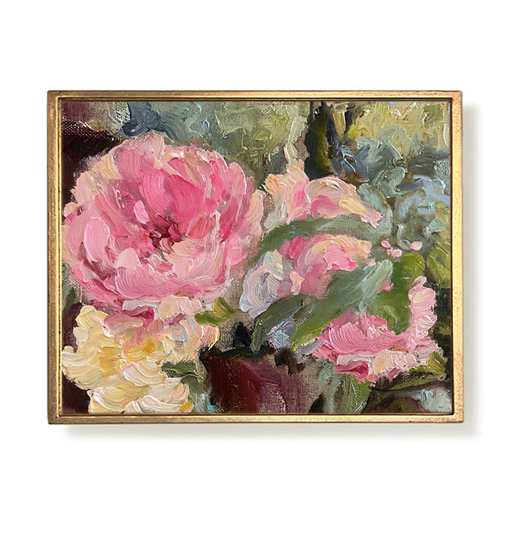 Framed painting of pink and yellow flowers with a gold frame on a white background