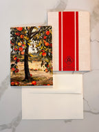 Framed artwork of an apple tree with a red and white striped box on a marble surface