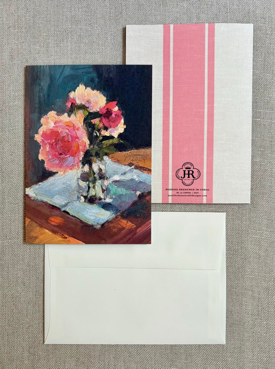 A stationery set featuring a printed card with an oil painting of pink roses in a glass vase, a white envelope, and a white envelope cover with pink vertical stripes and a circular 'The HR' monogram logo.