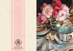 A split design featuring a cream linen-textured left panel with pink vertical stripes and a black logo reading Premier in Cream, alongside a painted still life of pink flowers in a silver pitcher and a white teacup on the right.