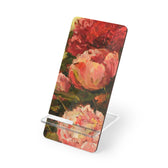 A pink peony phone stand by artist Jennifer Hansen Rolli.