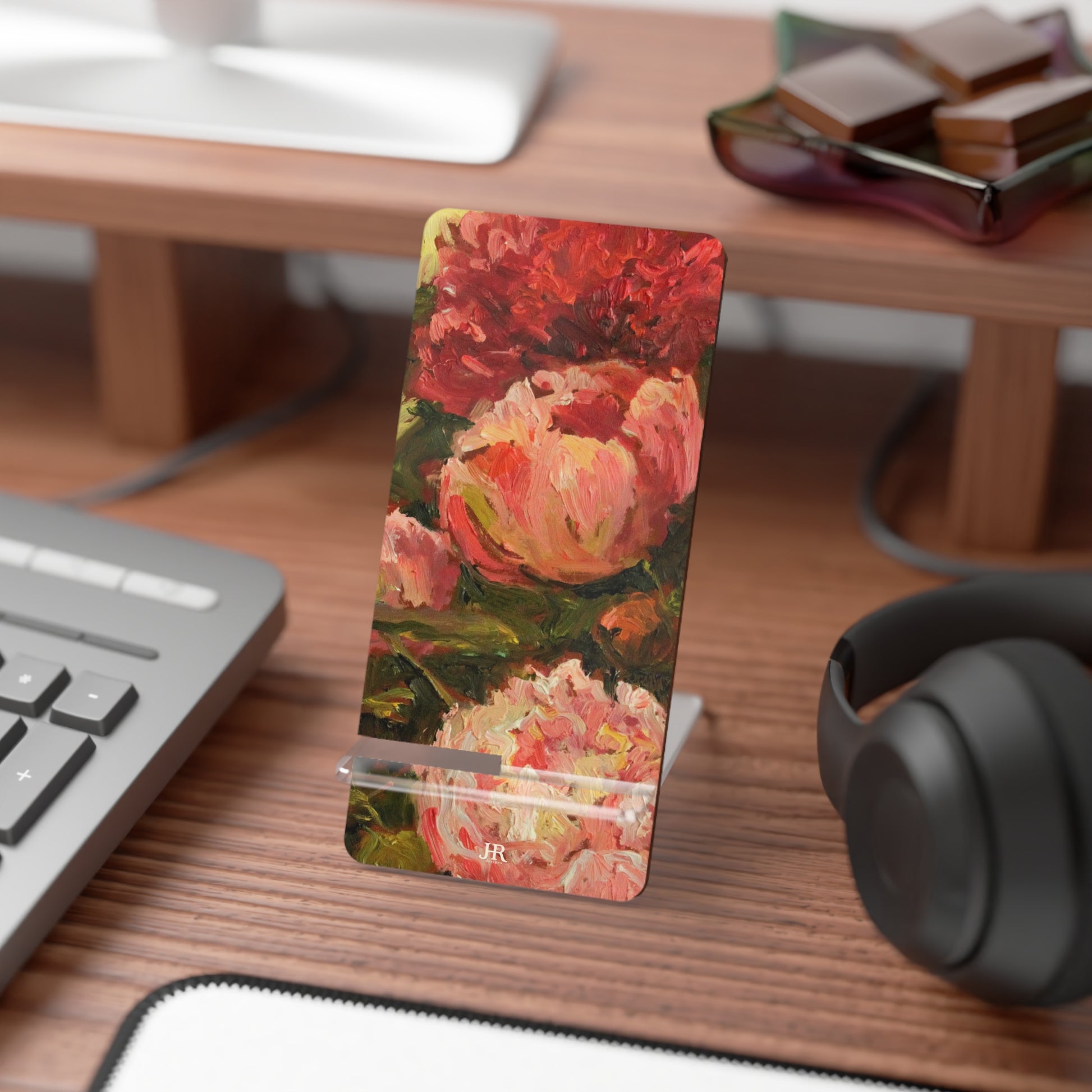 A pink peony phone stand on desk by artist Jennifer Hansen Rolli.