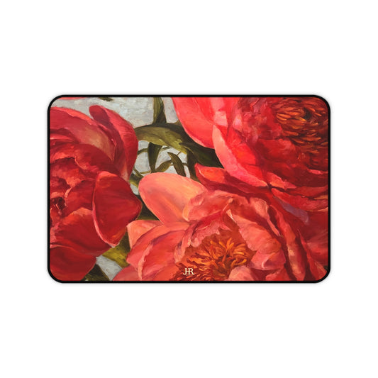 A desk mat featuring the red peony painting of artist Jennifer Hansen Rolli.