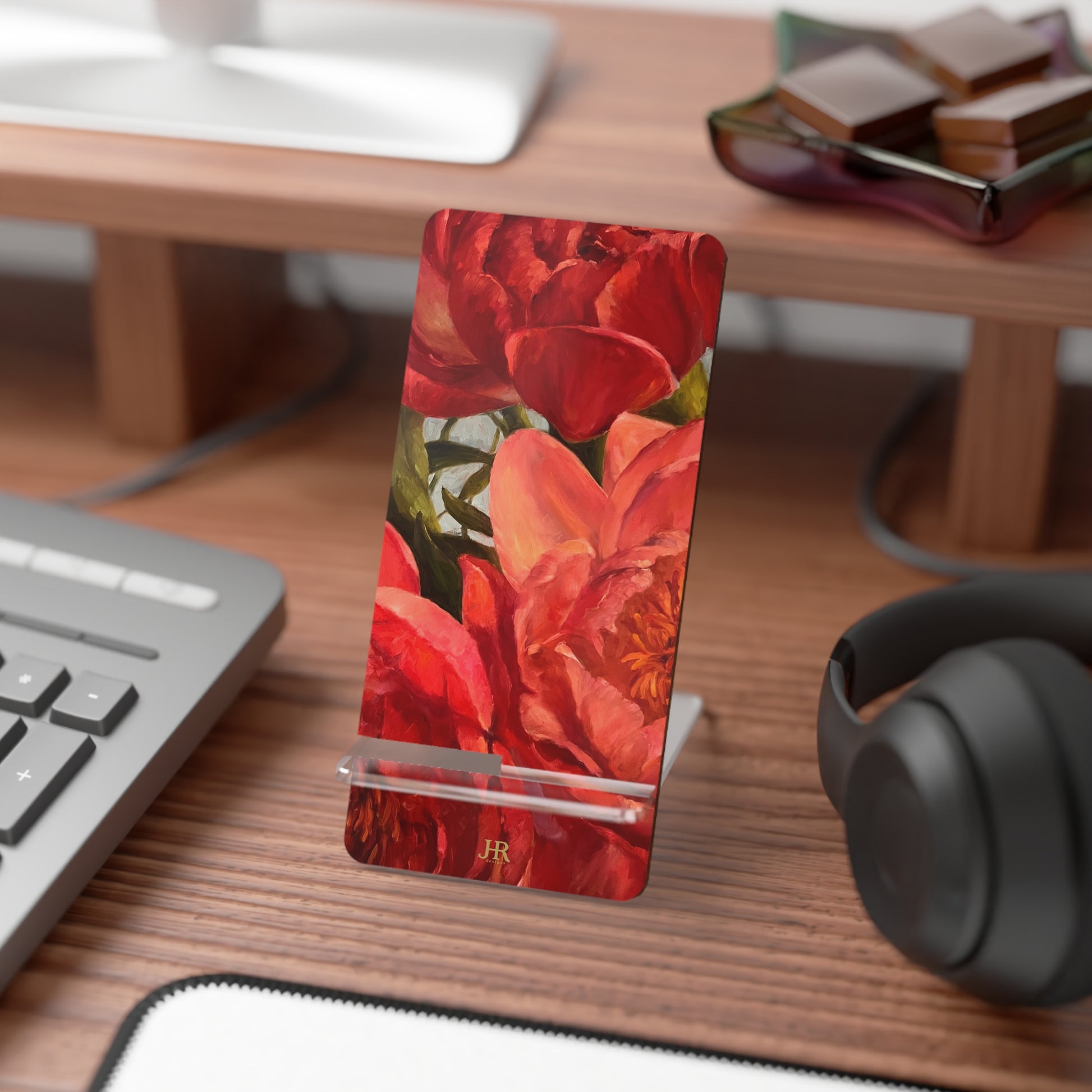 A red peony phone stand on desk by artist Jennifer Hansen Rolli.