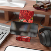 A red peony phone stand with phone by artist Jennifer Hansen Rolli.