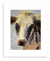 A framed Sterotypical cow print by artist Jennifer Hansen Rolli.