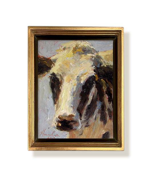 A framed Sterotypical cow painting by artist Jennifer Hansen Rolli.