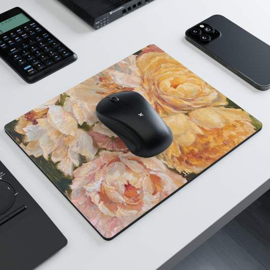 A mousepad shown on a desk featuring the yellow peony artwork of artist Jennifer Hansen Rolli.