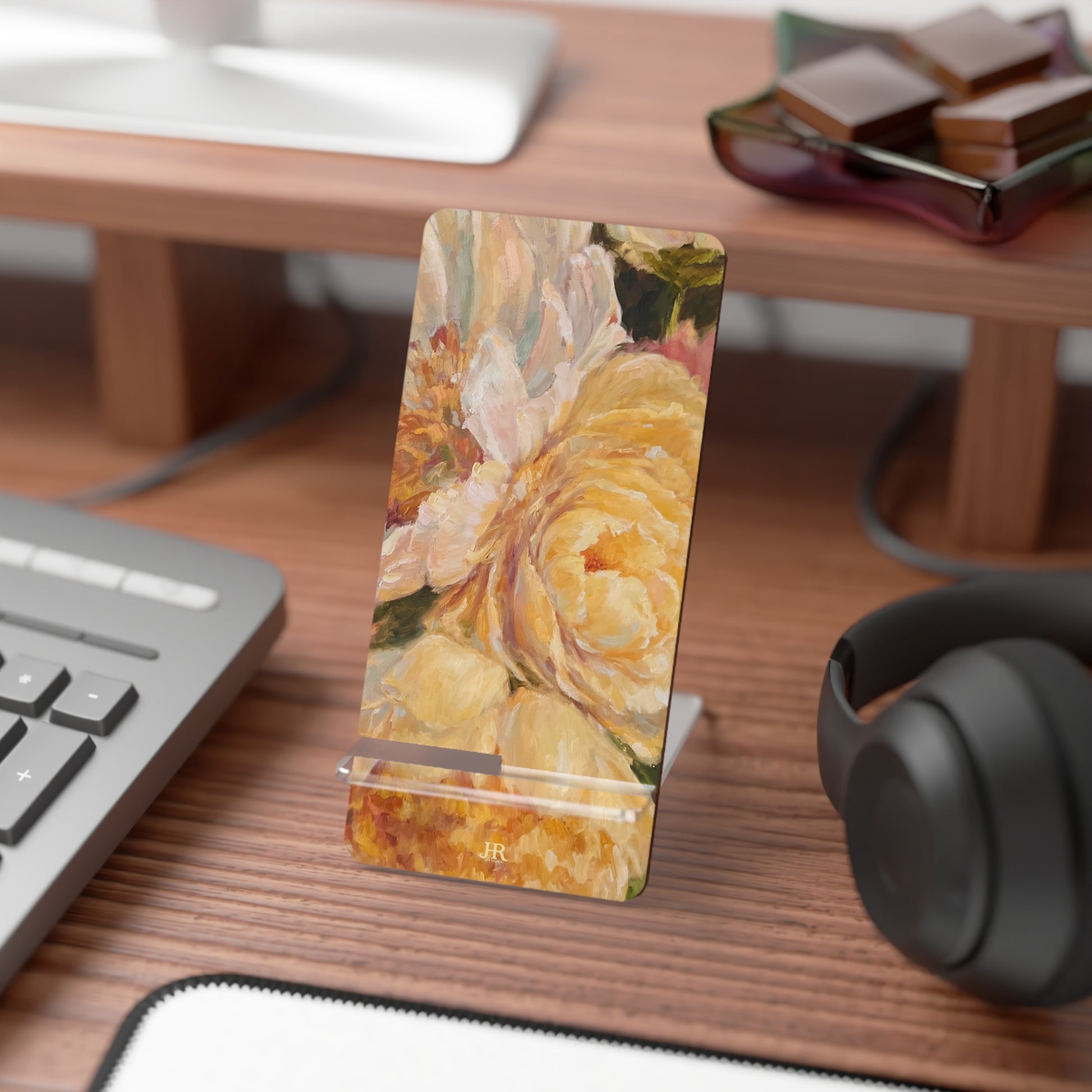 A yellow peony phone stand on desk by artist Jennifer Hansen Rolli.